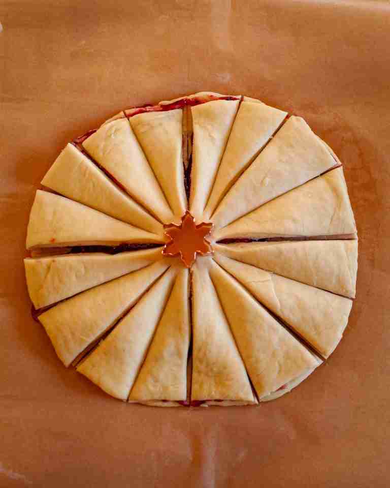 Snowflake pastry cut into 16 sections with a small snowflake cutter in the center. 